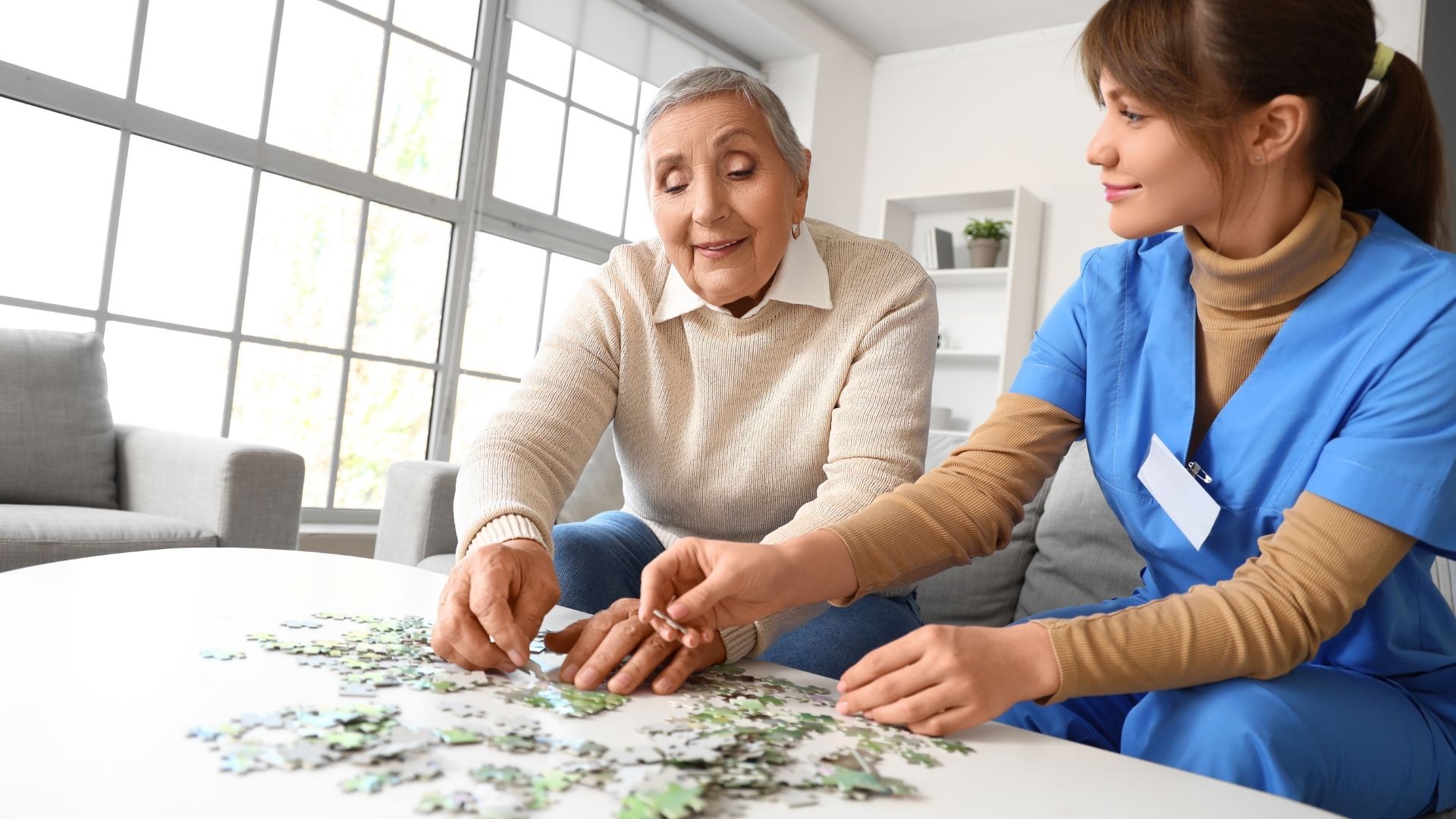 Elderly person sitting with a caregiver at home, representing Alzheimer's patients and families exploring medical marijuana evaluation options in Ohio through KAV THC